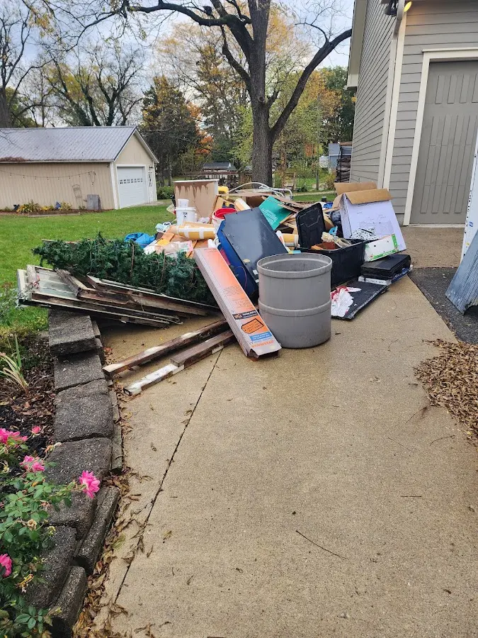 Dumpster being loaded with debris for Estate Cleanout Dumpster Rental in Peru
